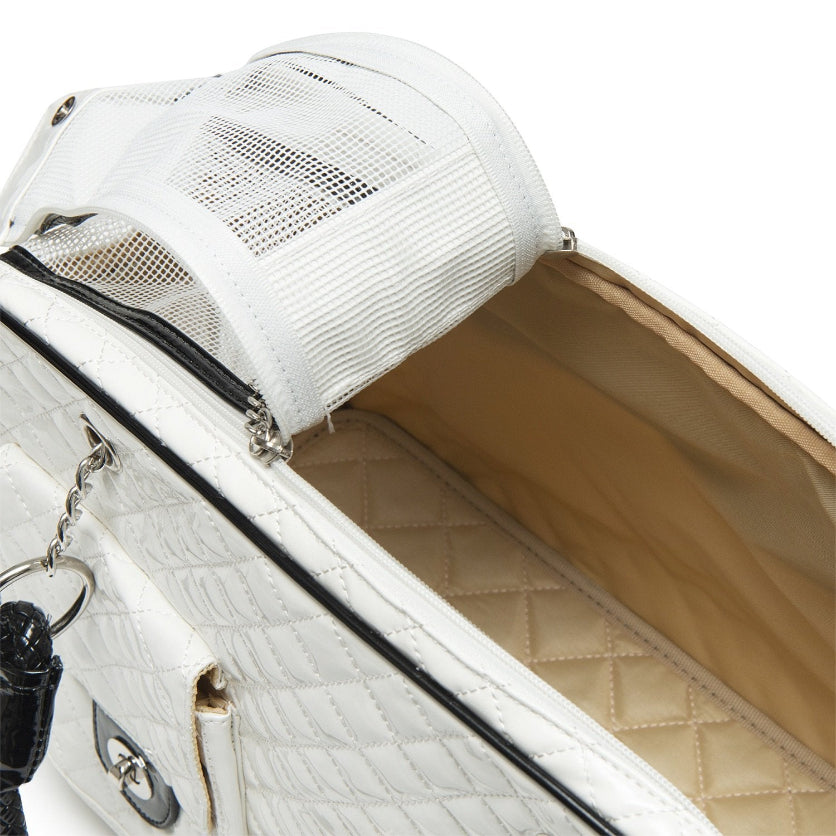 White handbag with quilted interior and mesh top, on a white background