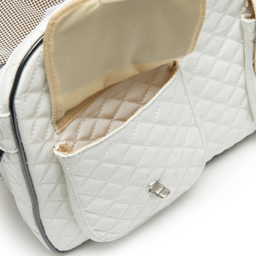 White quilted handbag with beige interior on a light gray background