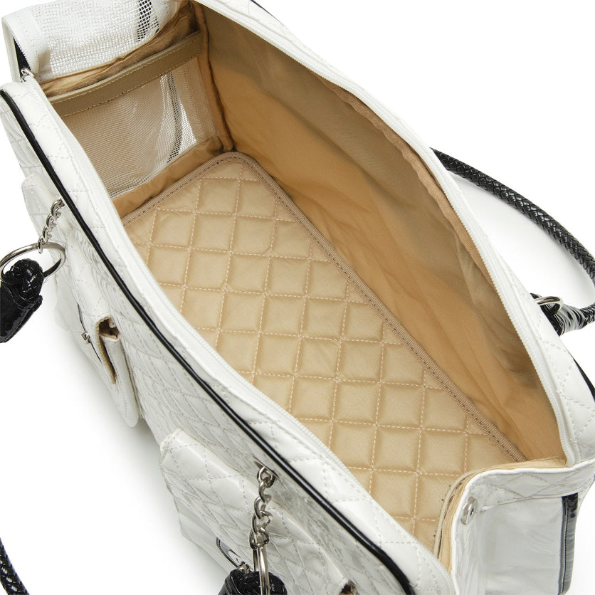 White handbag with quilted beige interior on a white background