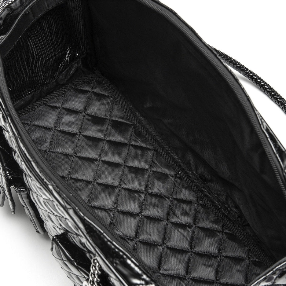Close-up of a black quilted handbag with a chain detail on a white background